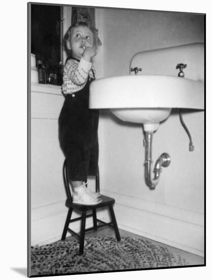 A Young Girl Brushes Her Teeth at the Sink, Ca. 1955-null-Mounted Photographic Print