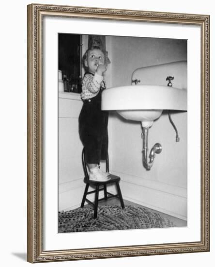 A Young Girl Brushes Her Teeth at the Sink, Ca. 1955-null-Framed Photographic Print