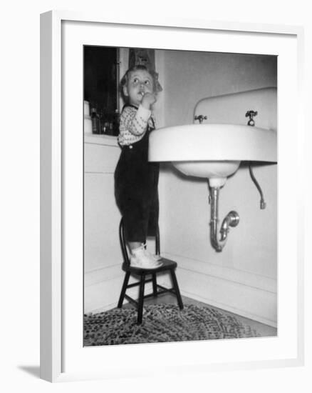 A Young Girl Brushes Her Teeth at the Sink, Ca. 1955-null-Framed Photographic Print