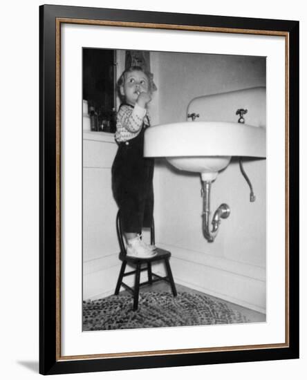 A Young Girl Brushes Her Teeth at the Sink, Ca. 1955-null-Framed Photographic Print