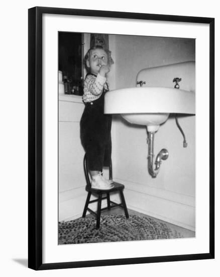 A Young Girl Brushes Her Teeth at the Sink, Ca. 1955-null-Framed Photographic Print