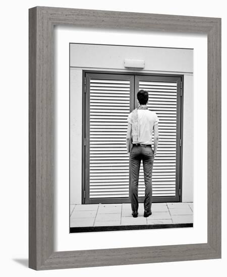 A Young Man Standing in the Street Looking at a Pair of Doors-India Hobson-Framed Photographic Print