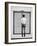 A Young Man Standing in the Street Looking at a Pair of Doors-India Hobson-Framed Photographic Print