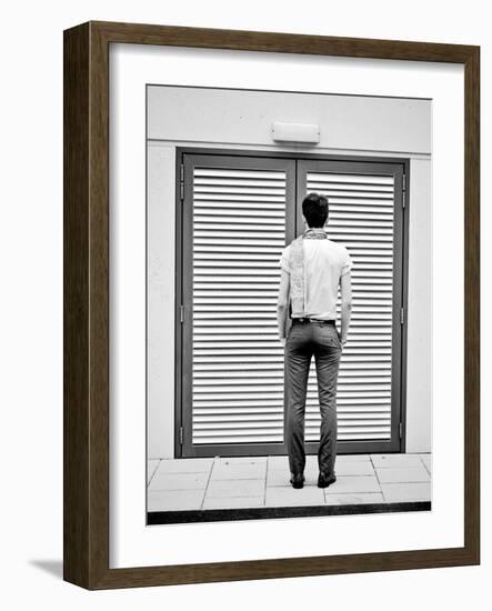 A Young Man Standing in the Street Looking at a Pair of Doors-India Hobson-Framed Photographic Print