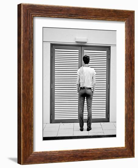 A Young Man Standing in the Street Looking at a Pair of Doors-India Hobson-Framed Photographic Print