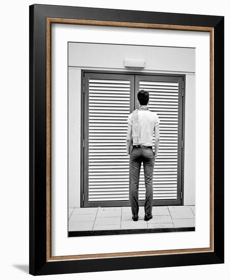 A Young Man Standing in the Street Looking at a Pair of Doors-India Hobson-Framed Photographic Print