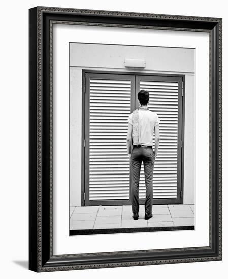 A Young Man Standing in the Street Looking at a Pair of Doors-India Hobson-Framed Photographic Print