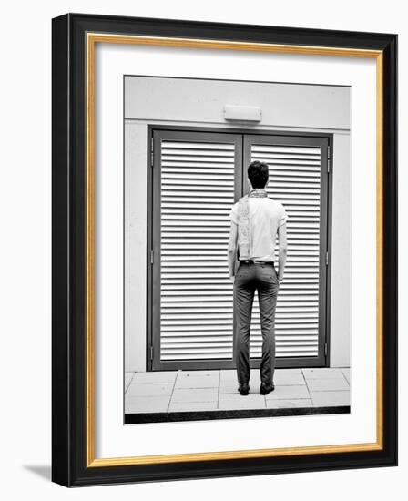 A Young Man Standing in the Street Looking at a Pair of Doors-India Hobson-Framed Photographic Print