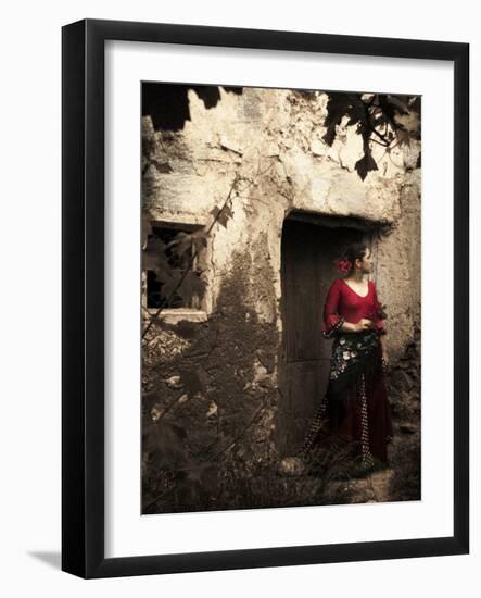A Young Spanish Woman Wearing Traditional Flamenco Dress Standing in a Doorway to an Old Building-Steven Boone-Framed Photographic Print