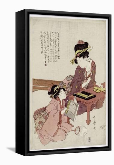 A Young Woman Seated at a Desk, Writing, a Girl with a Book Looks On-Kitagawa Utamaro-Framed Premier Image Canvas