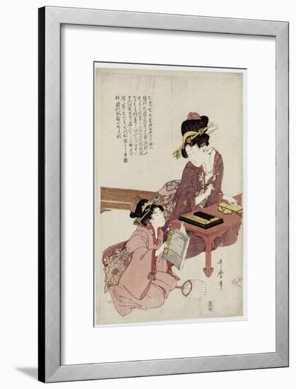 A Young Woman Seated at a Desk, Writing, a Girl with a Book Looks On-Kitagawa Utamaro-Framed Giclee Print