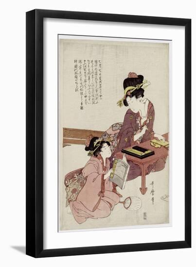 A Young Woman Seated at a Desk, Writing, a Girl with a Book Looks On-Kitagawa Utamaro-Framed Giclee Print