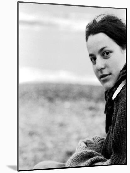 A Young Woman Sitting Near the Sea Wearing a Thick Jumper-RedHeadPictures-Mounted Photographic Print
