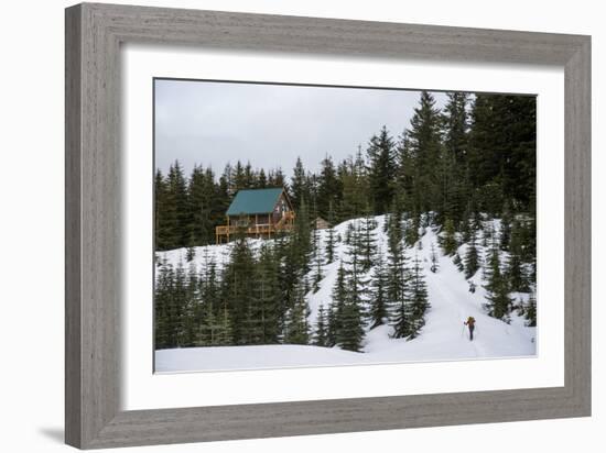 A Young Woman Skins Up A Hill Towards A Hut In The Backcountry Near Mt Rainier National Park, Wa-Michael Hanson-Framed Photographic Print