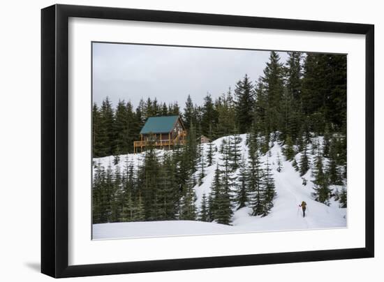 A Young Woman Skins Up A Hill Towards A Hut In The Backcountry Near Mt Rainier National Park, Wa-Michael Hanson-Framed Photographic Print