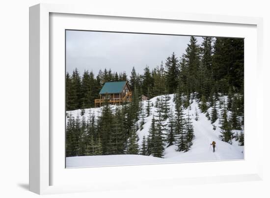 A Young Woman Skins Up A Hill Towards A Hut In The Backcountry Near Mt Rainier National Park, Wa-Michael Hanson-Framed Photographic Print