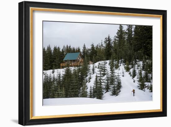 A Young Woman Skins Up A Hill Towards A Hut In The Backcountry Near Mt Rainier National Park, Wa-Michael Hanson-Framed Photographic Print