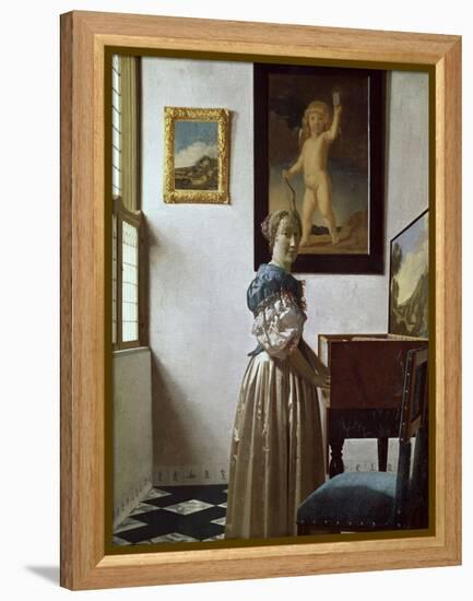 A Young Woman Standing at a Virginal. C.1670-Johannes Vermeer-Framed Premier Image Canvas