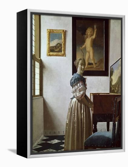 A Young Woman Standing at a Virginal. C.1670-Johannes Vermeer-Framed Premier Image Canvas