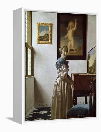 A Young Woman Standing at a Virginal. C.1670-Johannes Vermeer-Framed Premier Image Canvas