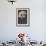 A Young Woman with Long Plaits Sticks Her Head Through a Flower-null-Framed Photographic Print displayed on a wall