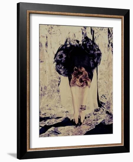 A Young Woman with Red Hair Leaning Forward and Touching Her Toes-India Hobson-Framed Photographic Print