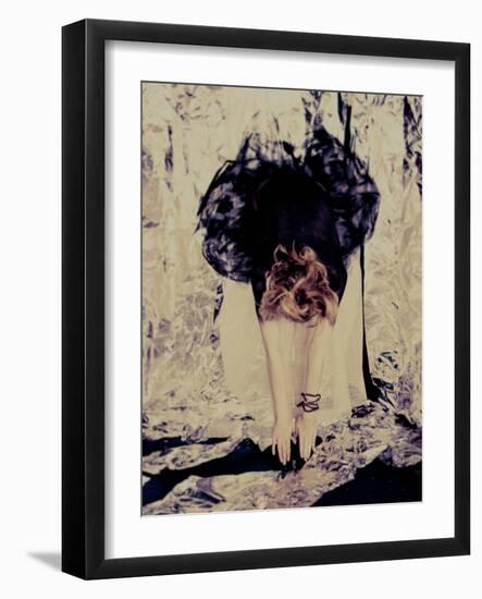 A Young Woman with Red Hair Leaning Forward and Touching Her Toes-India Hobson-Framed Photographic Print