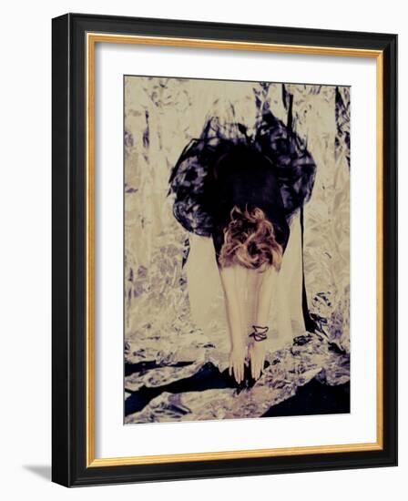 A Young Woman with Red Hair Leaning Forward and Touching Her Toes-India Hobson-Framed Photographic Print