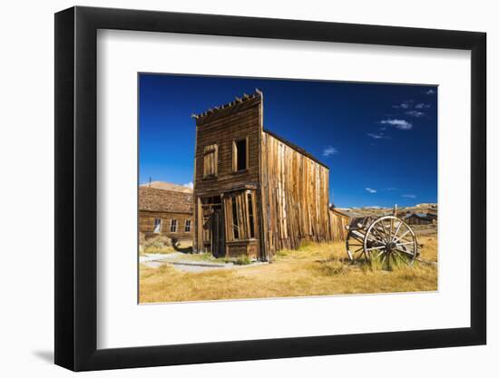 Abandoned ghost town building and wagon, Bodie State Historic Park, California, USA-Russ Bishop-Framed Photographic Print