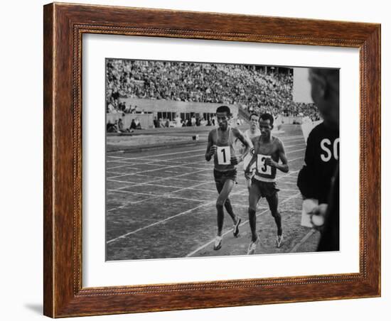 Abebe Bikila and Mamo Wolde in Exhibition Race at Berlin Olympic Stadium-null-Framed Premium Photographic Print