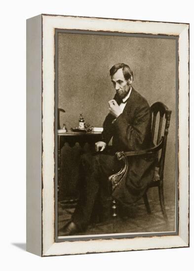 Abraham Lincoln Sitting at Desk, 1861-Mathew Brady-Framed Premier Image Canvas