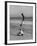 Acrobat/Actor, Russ Tamblyn Doing a Flip on Beach with Movie Actress Venetia Stevenson Watching Him-Allan Grant-Framed Premium Photographic Print