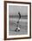 Acrobat/Actor, Russ Tamblyn Doing a Flip on Beach with Movie Actress Venetia Stevenson Watching Him-Allan Grant-Framed Premium Photographic Print