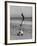 Acrobat/Actor, Russ Tamblyn Doing a Flip on Beach with Movie Actress Venetia Stevenson Watching Him-Allan Grant-Framed Premium Photographic Print