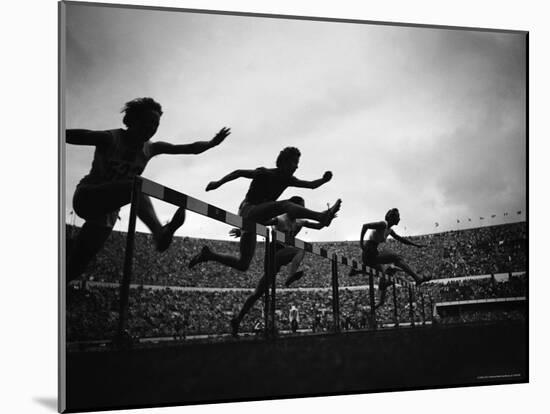 Action During the Women's 100m Hurdles at the 1952 Olympic Games in Helsinki-Mark Kauffman-Mounted Photographic Print