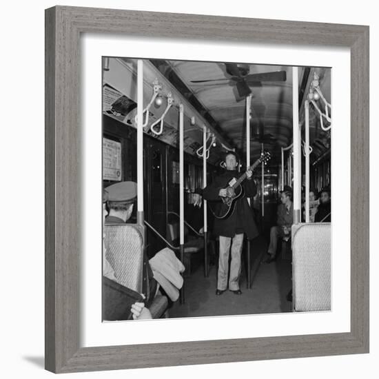 Activist Folk Musician Woody Guthrie Playing for a Subway Car of New Yorkers-Eric Schaal-Framed Premium Photographic Print