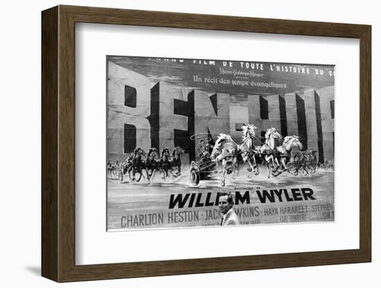 Actor Charlton Heston Posing in Front of Billboard of Film, Ben Hur-null-Framed Photographic Print