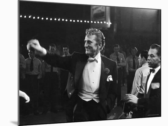 Actor Kirk Douglas, Smiling and Waving as He Enters RKO Pantages Theatre, For the Academy Awards-Ed Clark-Mounted Premium Photographic Print