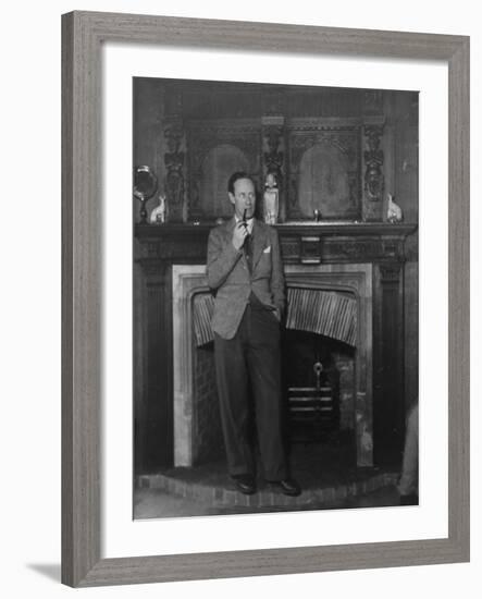 Actor Leslie Howard Smoking Pipe as He Stands by His Fireplace, at Home in Dorking, England-null-Framed Premium Photographic Print