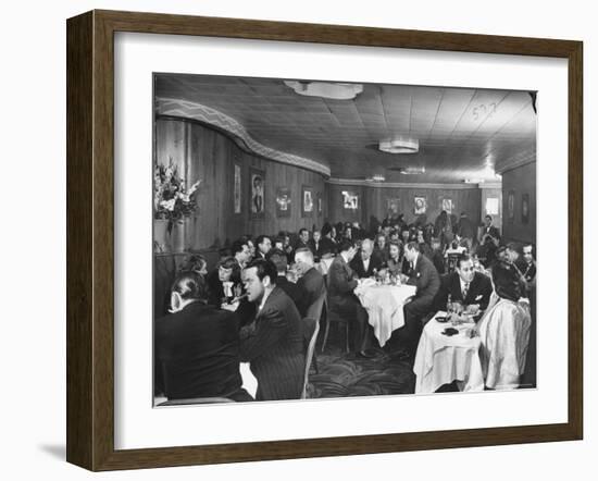 Actor Orson Welles at Table on Left with Cigar in His Mouth-Alfred Eisenstaedt-Framed Premium Photographic Print