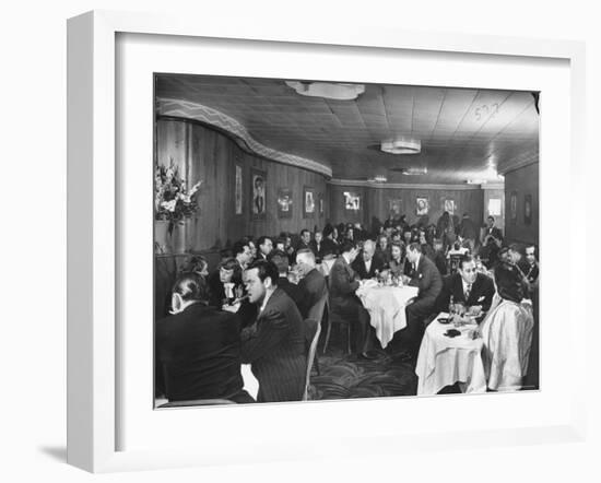 Actor Orson Welles at Table on Left with Cigar in His Mouth-Alfred Eisenstaedt-Framed Premium Photographic Print