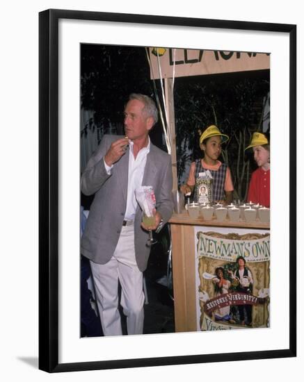 Actor Paul Newman Standing Next to a Stand Sell Newman's Own Virgin Lemonade-null-Framed Premium Photographic Print