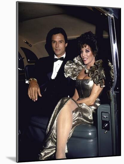 Actors Michael Nader and Joan Collins Sitting in a Car-John Paschal-Mounted Premium Photographic Print