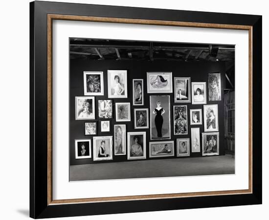 Actress Barbara Rush Posing in a Frame Cut-Out on a Wall Full of Paintings of Herself, 1960-Ralph Crane-Framed Photographic Print