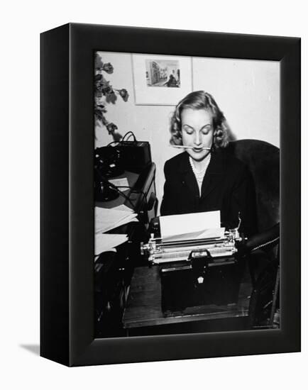 Actress Carole Lombard Typing While Holding Pencil Firmly in Her Mouth-Rex Hardy Jr.-Framed Premier Image Canvas