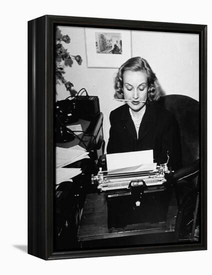 Actress Carole Lombard Typing While Holding Pencil Firmly in Her Mouth-Rex Hardy Jr.-Framed Premier Image Canvas