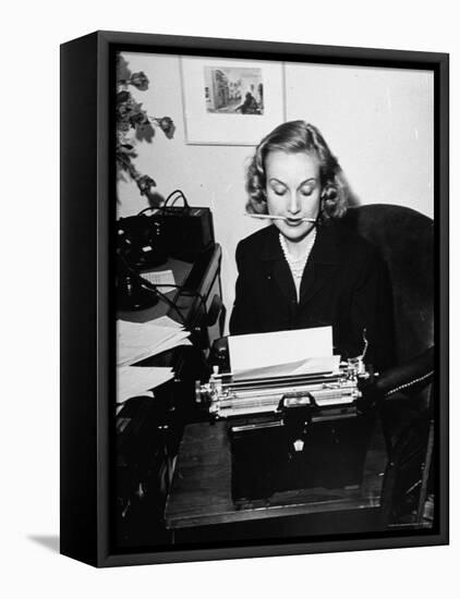 Actress Carole Lombard Typing While Holding Pencil Firmly in Her Mouth-Rex Hardy Jr.-Framed Premier Image Canvas