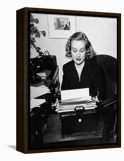 Actress Carole Lombard Typing While Holding Pencil Firmly in Her Mouth-Rex Hardy Jr.-Framed Premier Image Canvas