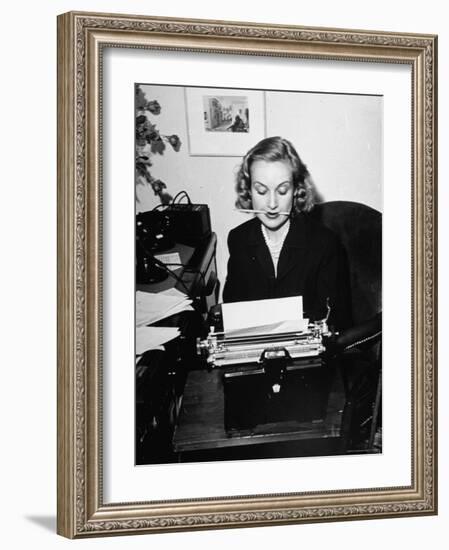 Actress Carole Lombard Typing While Holding Pencil Firmly in Her Mouth-Rex Hardy Jr.-Framed Premium Photographic Print