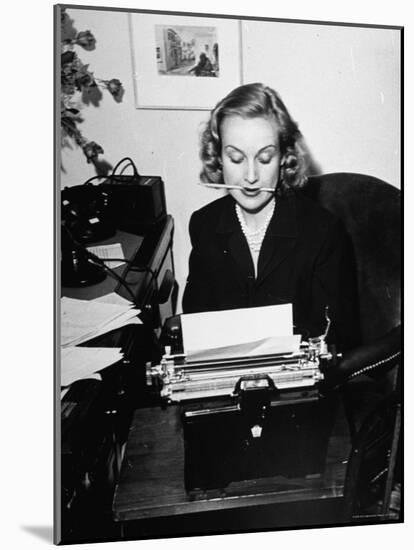 Actress Carole Lombard Typing While Holding Pencil Firmly in Her Mouth-Rex Hardy Jr.-Mounted Premium Photographic Print